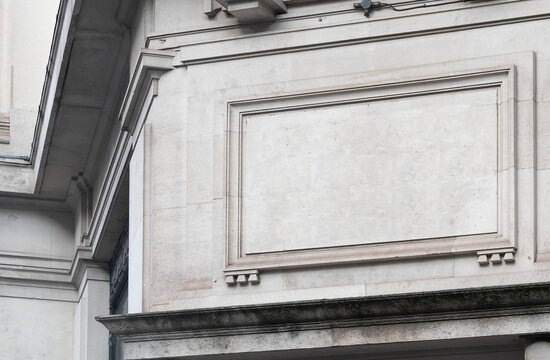 Blank stone billboard frame on historic building facade with copy space for advertising
