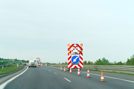Roadwork scene with barriers and traffic redirection