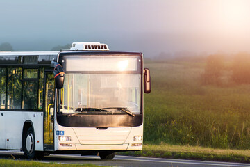 Empty travel bus on a beautiful nature road © AlexGo