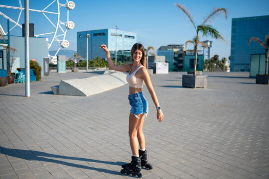 Young woman rollerblading having fun in Barcelona city