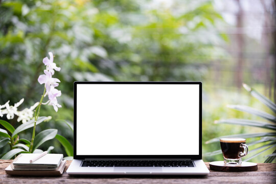Laptop with white screen and coffee cup