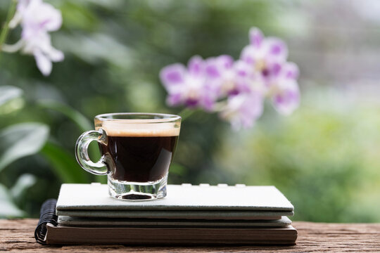 Closeup of coffee on stack of notebooks