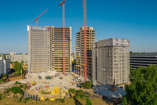 Aerial view of the construction site at Kaiserlei featuring gutted KWU towers undergoing dismantling with red cranes and scaffolding in Offenbach am Main, Hessen, Germany.