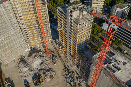 Aerial view of the Kaiserlei construction site featuring gutted KWU towers undergoing dismantling with tall red cranes and debris in Offenbach am Main, Hessen, Germany.