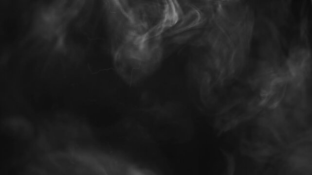 White swirling smoke against a black background