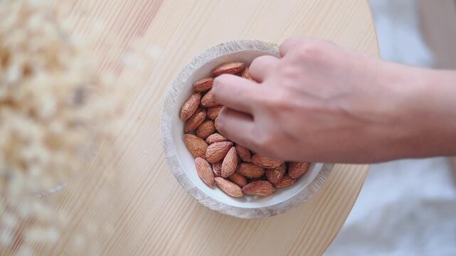 Almonds in a bowl on a wooden table