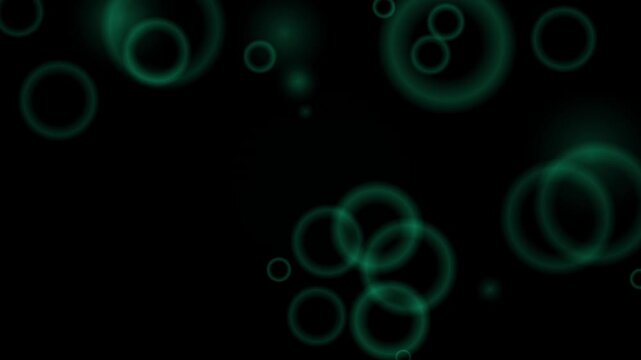 Abstract green light circles float in a repeating loop pattern on a black background