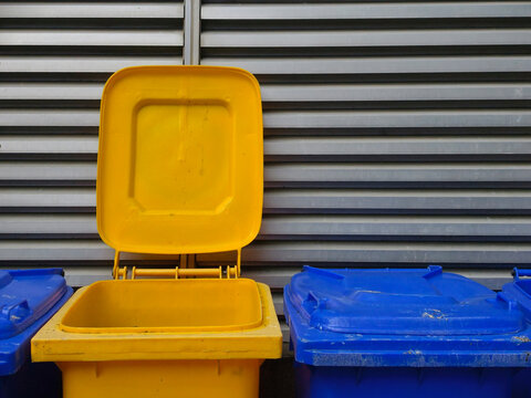Yellow plastic container in the trash can.