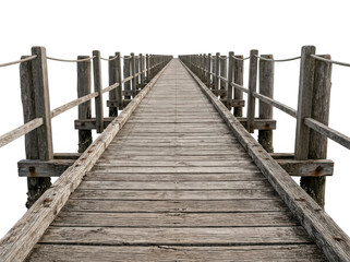 Obraz premium Wooden pier extending into calm water. Long weathered dock with metal railings leading to horizon.
