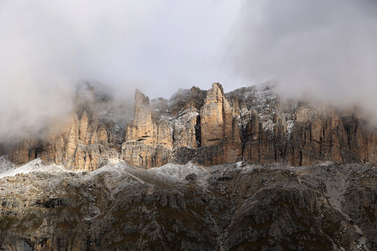 The Sass Pordoi - Pordoi Pass- in the Sella Group Dolomites rises from the fog, South Tyrol, Italy