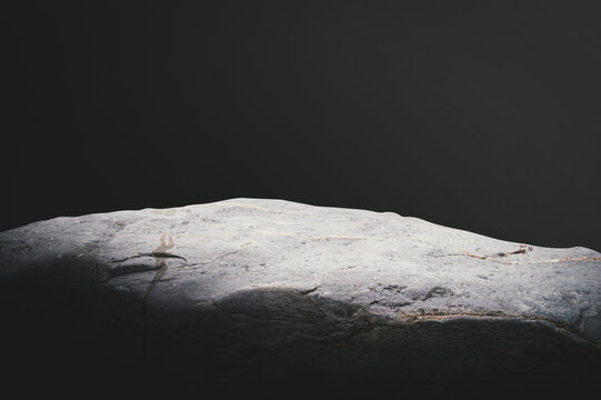 Smooth Grey Stone Pedestal with Dramatic Studio Lighting.
