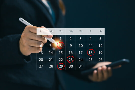 Businesswoman planning schedule on digital calendar using smartphone and tablet, managing appointments, deadlines, time management and business organization with modern online productivity technology.