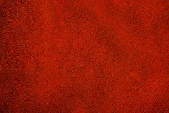 Red leather texture close up with smooth matte surface for fashion background and upholstery material