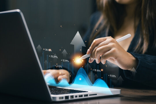 Businesswoman reviewing business performance dashboard with financial analytics, growth statistics, data visualization, KPI monitoring and digital reporting on laptop technology.
