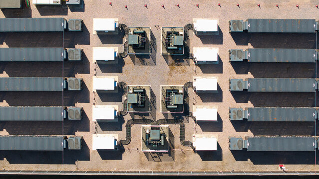 Aerial view of Nursling Substation 400kV and battery energy storage systems with rows of industrial containers and transformers on a gravel site in Nursling, England, United Kingdom.