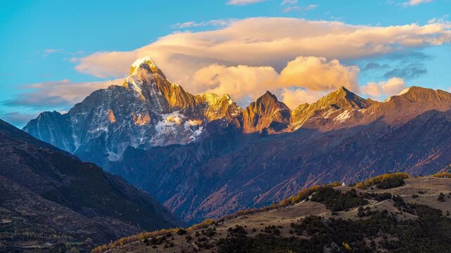 Time lapse of Siguniangshan or four girls mountains at sunset, China.