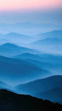 Misty blue mountain layers at sunrise serene landscape