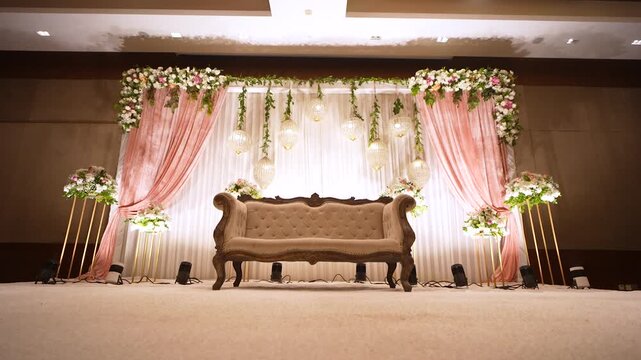 Elegant wedding stage decor in Mumbai, India. Luxury reception sofa with floral backdrop.