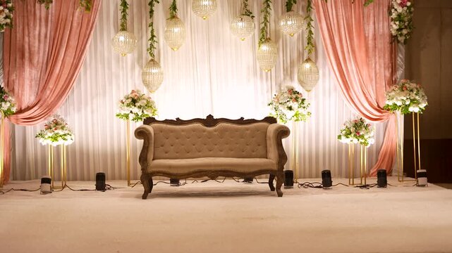 Luxury wedding stage decor in Mumbai, India. Elegant reception sofa with floral arrangements.