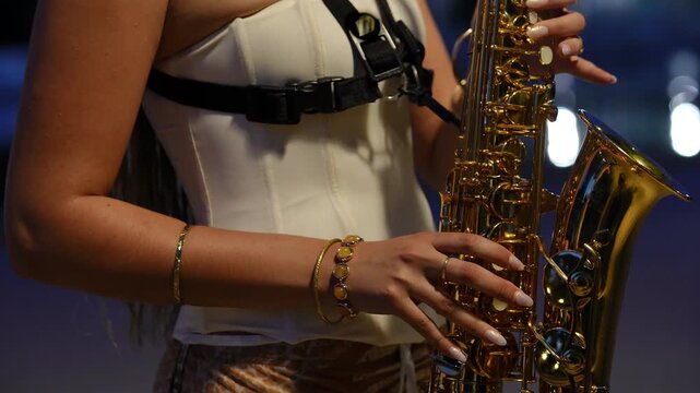 Close-up of a female musician playing the saxophone on stage