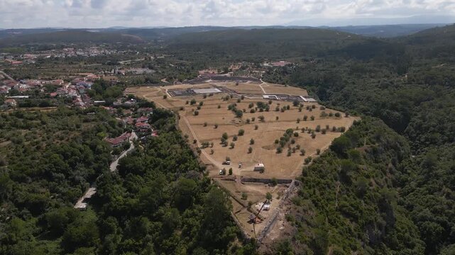 Elevated drone perspective highlighting Con&iacute;mbriga&rsquo;s archaeological complexity, including villa foundations, interconnected pathways, and decorative mosaic interiors. Drone moving forward.