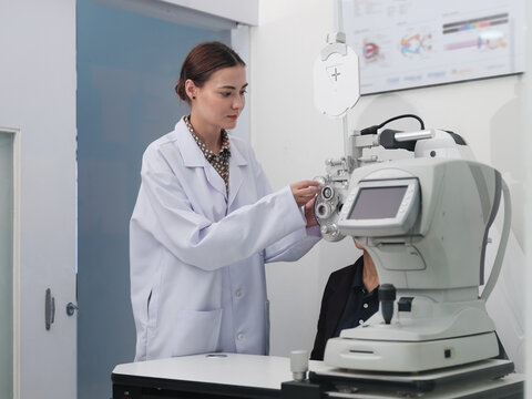 Female patient eye exam with refractometer device, vision and eyesight improvement by expert optometrist woman, diagnostic for eyeglasses lens, professional technology services in optical clinic.