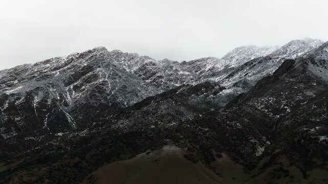 Drone shot of Utah's foothills covered with a light dusting of Spring snow.