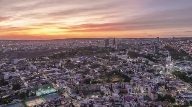 Sunset with a warm horizon. An urban landscape with streets lit by streetlights and car headlights.