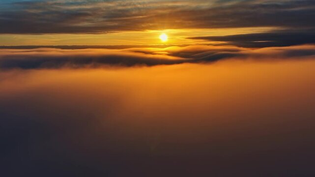 View of the twilight sky and the rosy sun shining through the clouds from the drone