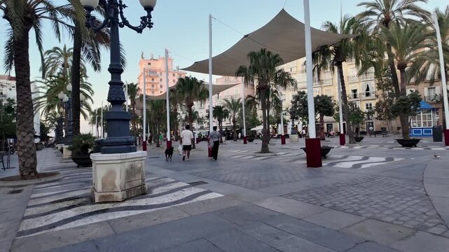 Pedestrians walking through Plaza de San Juan de Dios, Cadiz, Spain