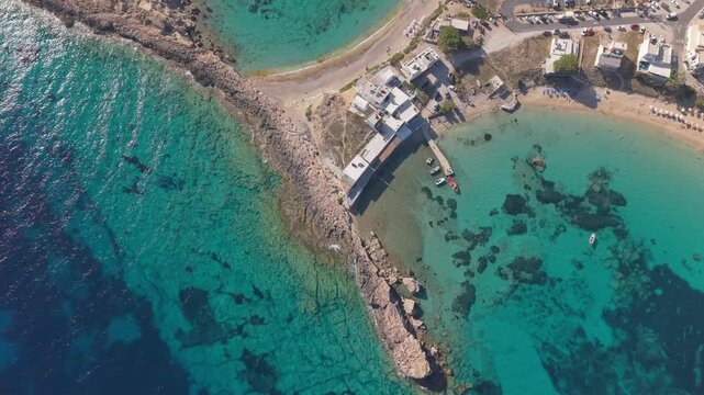 Drone approach unveiling the stunning location of Lefkos Beach, highlighting its turquoise waters, sandy coastline, and breathtaking scenery on Karpathos Island.
