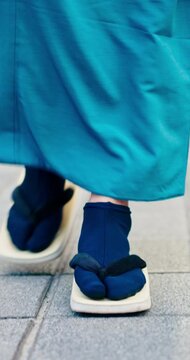 Man, walk and shoes with sidewalk, traditional outfit and sandals for heritage or summer fashion. Japanese person, zori and tabi for trip, culture and travel with casual kimono or yukata in city