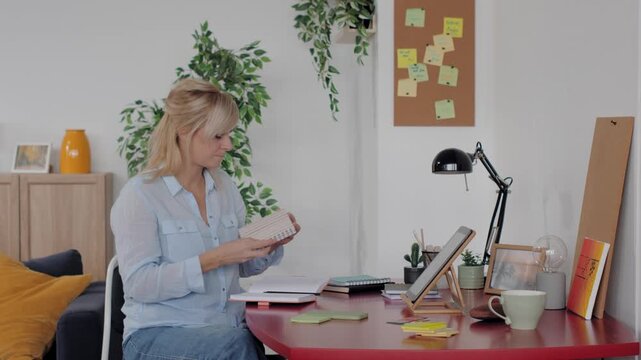 Mature businesswoman making a phone call from home office