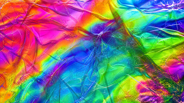 Holographic iridescent foil texture, vibrant rainbow metallic background, crumpled colorful plastic wrap surface, psychedelic neon abstract backdrop
