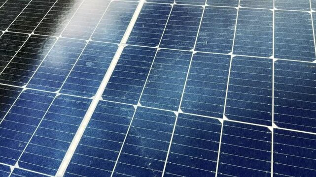 Close-up of Blue Solar Panel Surface with Sunlight Reflection