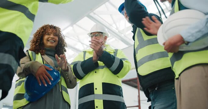 Happy, architect and team with hands together for building success, construction or mission. Low angle, people or group of contractors piling with stack, applause or smile for winning or celebration