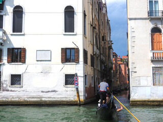 Gondola entering a narrow canal in Venice, Italy © Valentina