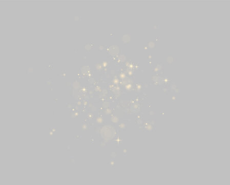 Scattered golden sparkles and glowing bokeh lights on a black background on transparent background