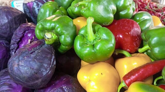 Assorted Fresh Vegetables Display with Red Cabbage and Bell Peppers at Market