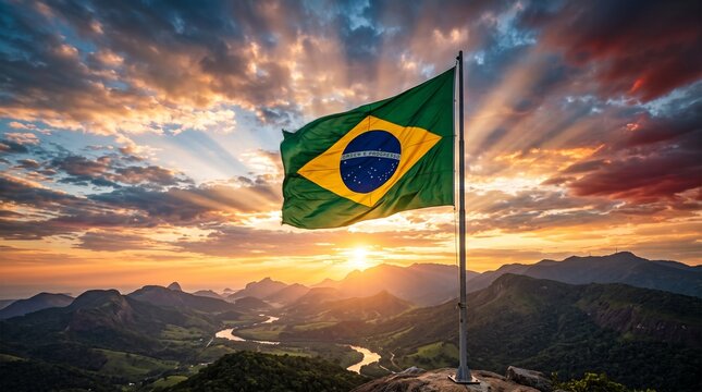 Brazilian flag waving over a scenic mountain landscape at sunrise