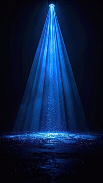 A bright blue spotlight illuminates a dark space with shimmering particles on the floor.