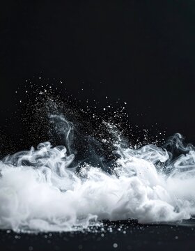 Dynamic white powder explosion against a dark background.
