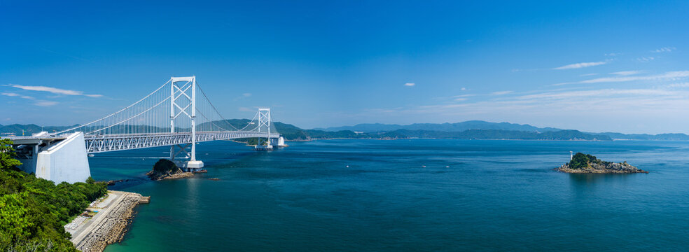 The impressive Onaruto suspension bridge spanning across the Naruto Strait with Tobishima Island in Japan.