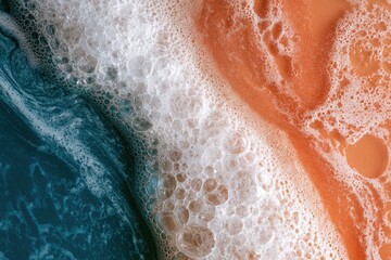 Fototapeta premium Abstract close-up of blue, white, and orange foamy liquid textures
