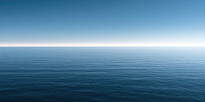 Calm, vast ocean under a clear blue sky, stretching to the horizon