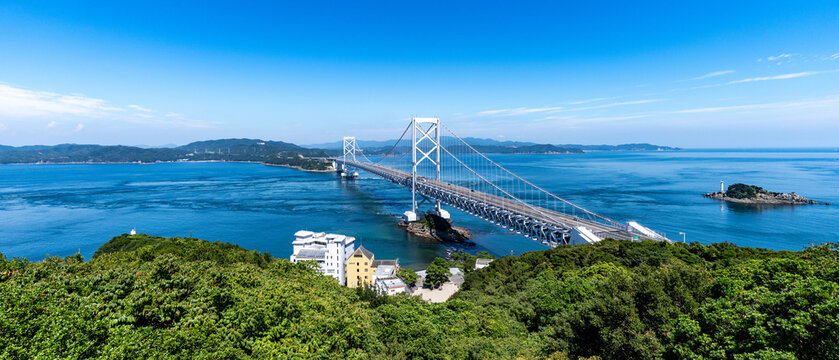 The impressive Onaruto suspension bridge spanning across the Naruto Strait with Tobishima Island in Japan.