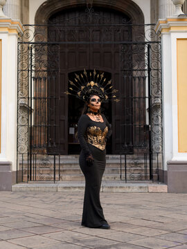 Woman With Day of the Dead Makeup and Golden Crown Outside Historic Building