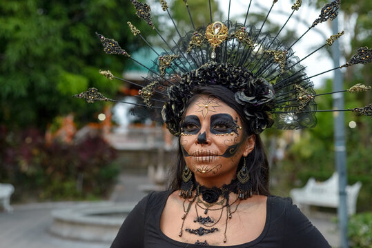 Woman Dressed as Catrina With Skull Makeup and Gothic Headdress for Day of the Dead