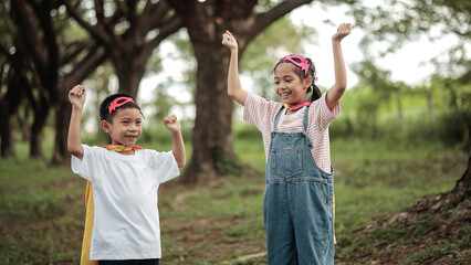 Obraz premium Happy Superhero Asian Kids Boy and Girl Power Pose Concept