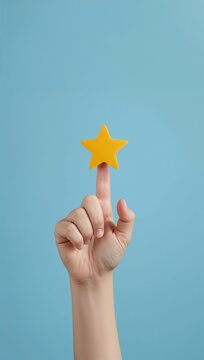 Hand holding a yellow star against a blue background, symbolizing achievement, quality, recognition, rating, and customer satisfaction.